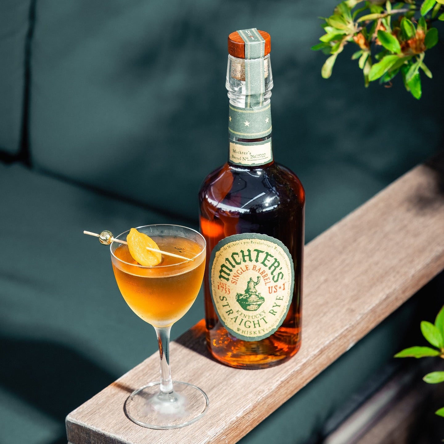Load image into Gallery viewer, Michter's Michter’s US1 Single Barrel Rye Whiskey bottle with a cocktail on a wooden ledge outdoors