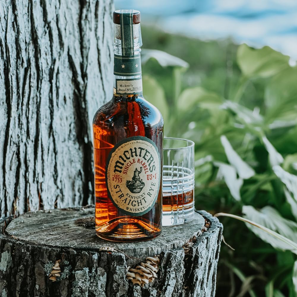 Load image into Gallery viewer, Bottle of Michter's Michter’s US1 Single Barrel Rye Whiskey on a wooden stump with a glass in the background.