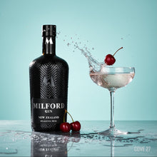 Load image into Gallery viewer, Milford Gin bottle with a cocktail and cherries on a light blue background