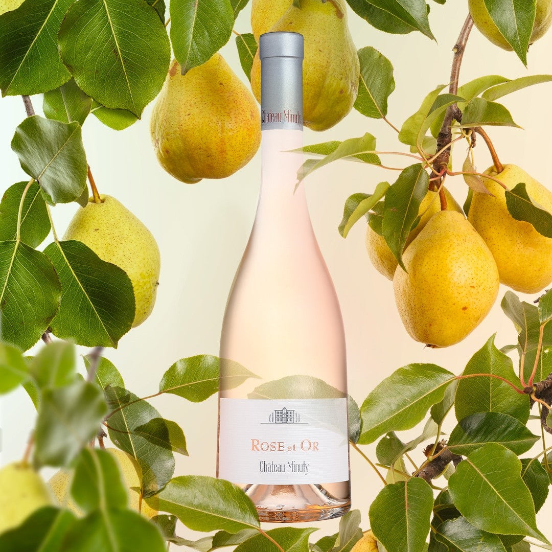 Load image into Gallery viewer, Bottle of Rose de Oru wine surrounded by pears on a tree