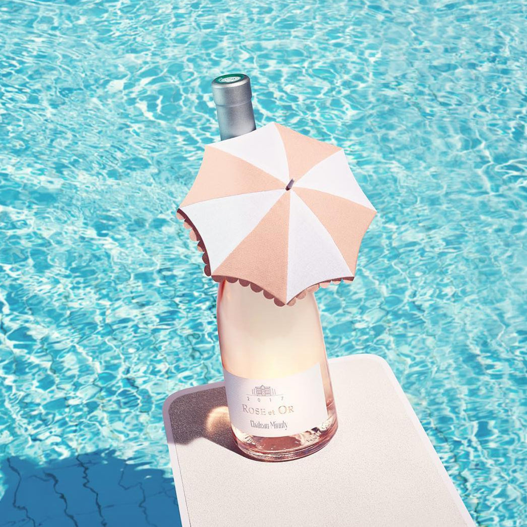 Load image into Gallery viewer, Bottle of Hennessy X.O with a pink umbrella on a diving board over blue water