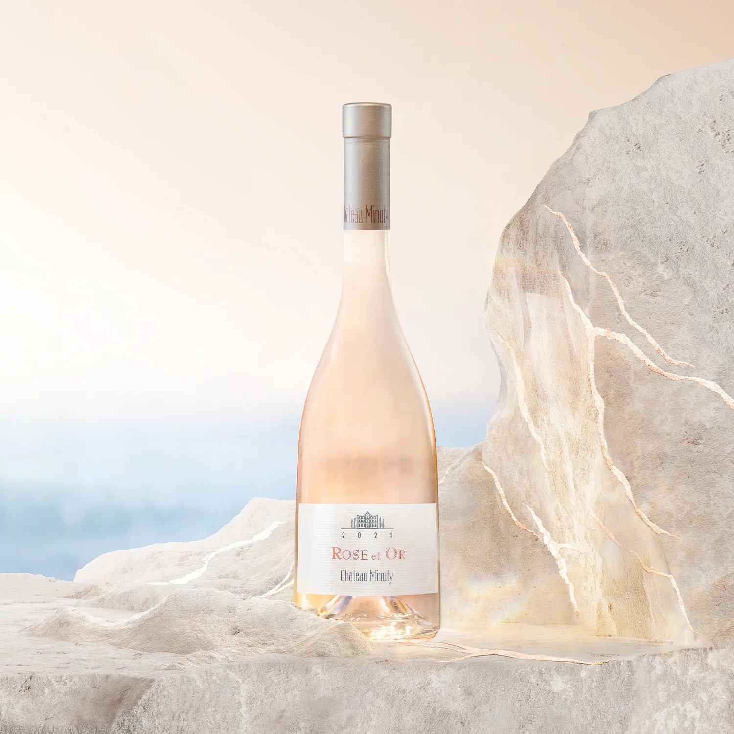 Load image into Gallery viewer, Bottle of Rose de Or wine on a textured surface with a soft background