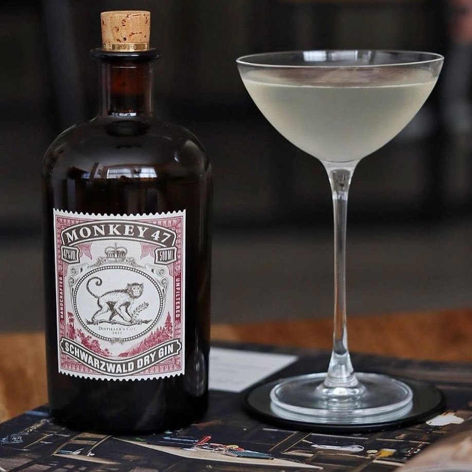Bottle of Monkey 47 gin with a cocktail glass on a table