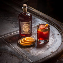 Load image into Gallery viewer, Bottle of Monkey 47 sloe gin with a cocktail on a metal tray