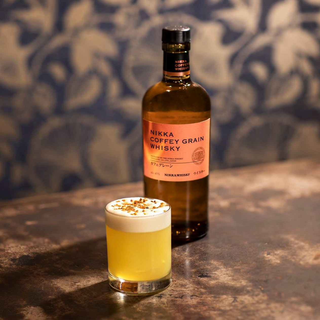 Load image into Gallery viewer, Whisky bottle with a glass of whisky cocktail on a textured surface.