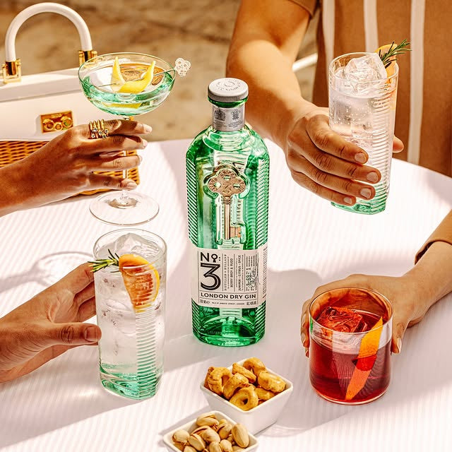 Load image into Gallery viewer, People enjoying drinks and snacks around a table with a bottle of No. 3 London Dry Gin.