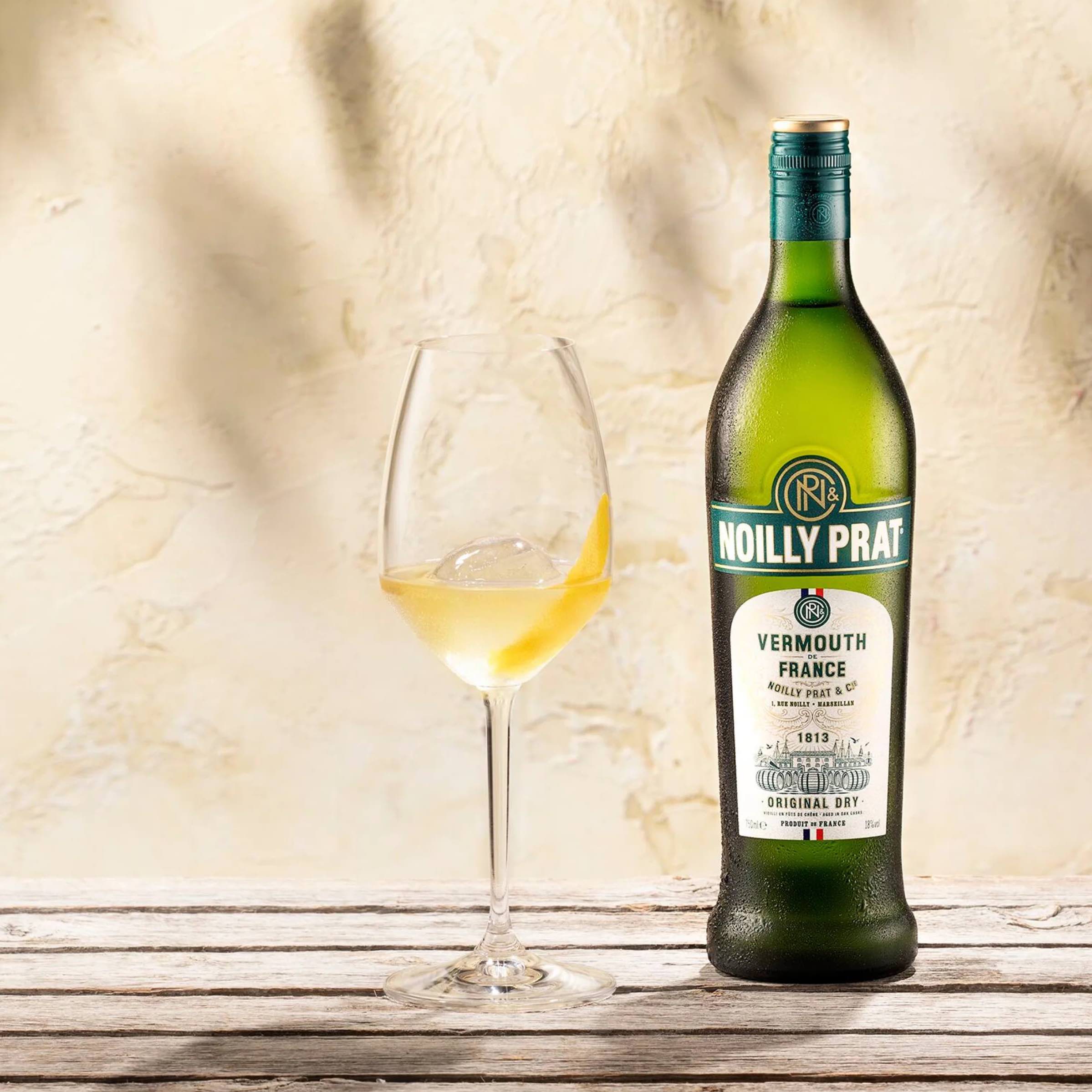 Load image into Gallery viewer, A bottle of Noilly Prat Original Dry Vermouth and a glass on a light background