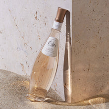 Load image into Gallery viewer, Ott Clos Mireille Cotes de Provence Rose bottle with a label on a textured stone surface