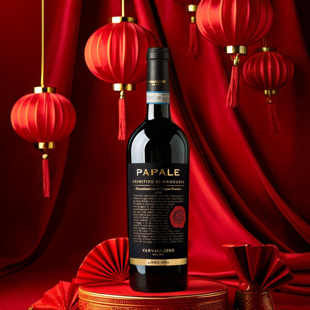 Load image into Gallery viewer, A Papale Oro Varvaglione Primitivo di Manduria red wine bottle on a red background with Chinese style decorative lanterns