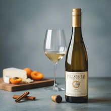 Load image into Gallery viewer, Bottle of Pegasus Bay Aria Late Picked Riesling white wine with a glass of wine and snacks on a table