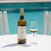 Load image into Gallery viewer, Bottle of Pegasus Bay Minuetto Sauvignon Semillon wine and a glass by a pool