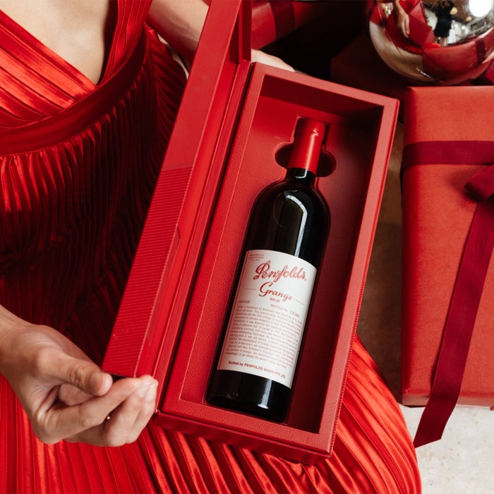 Load image into Gallery viewer, Penfolds Grange wine bottle in a red box held by a person in a red dress.