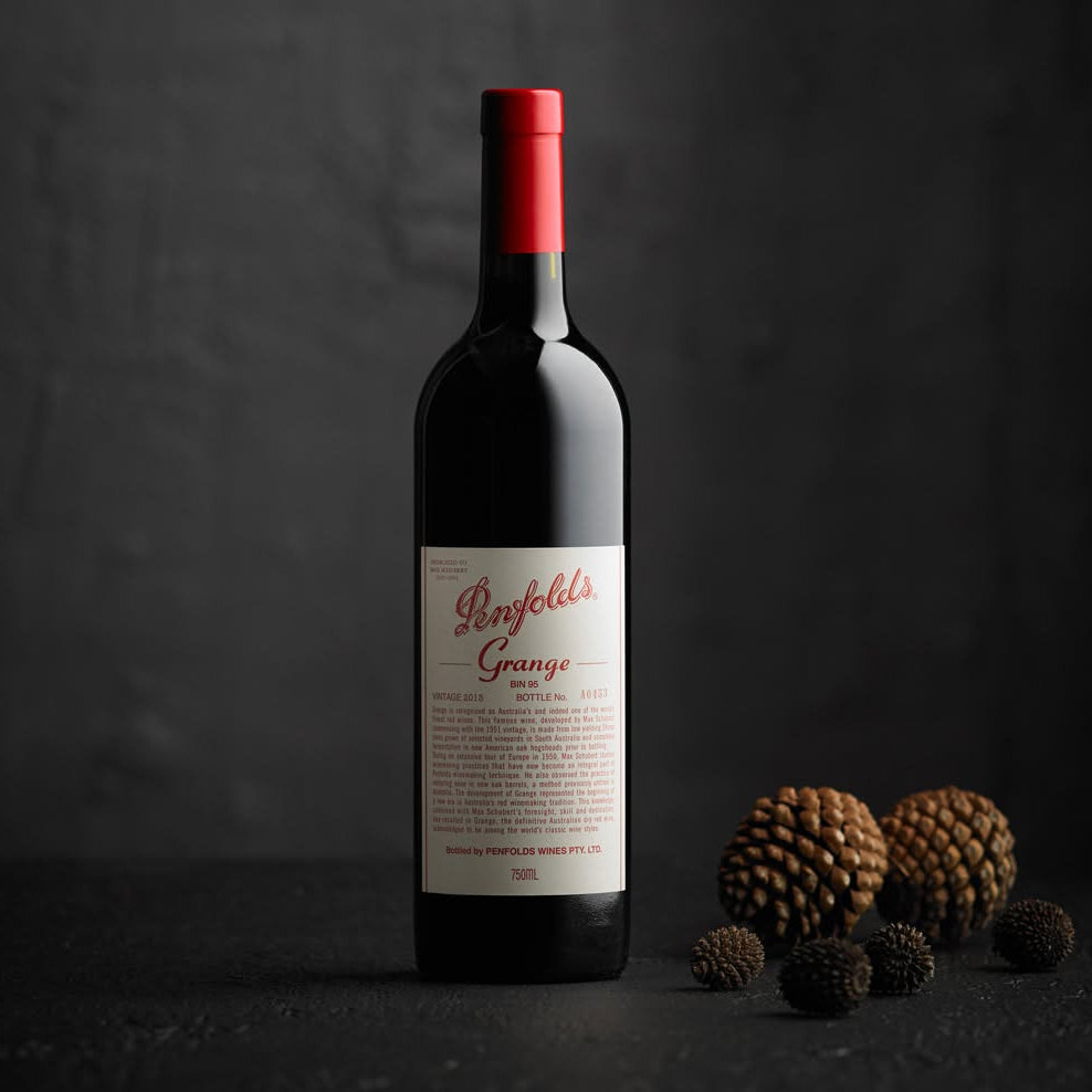 Load image into Gallery viewer, Penfolds Grange wine bottle with a red cap on a dark background