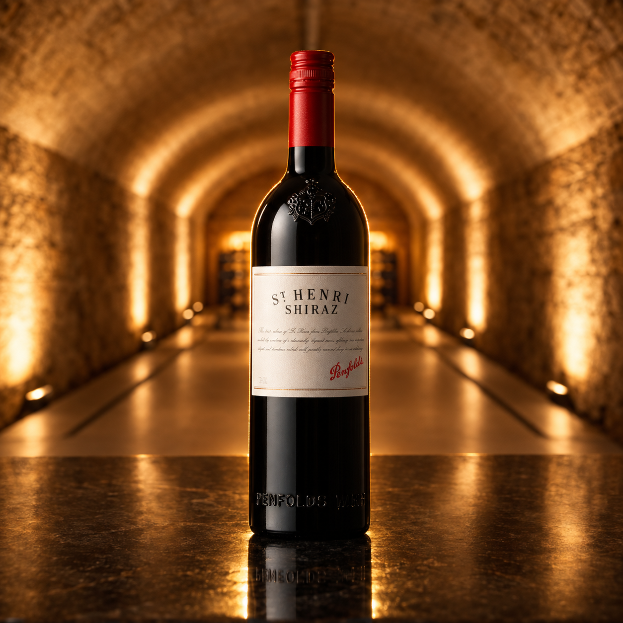 Load image into Gallery viewer, A bottle of St. Henri Shiraz red wine by Penfolds stands centered on a reflective dark surface, with a blurred stone tunnel illuminated by warm golden lights in the background.