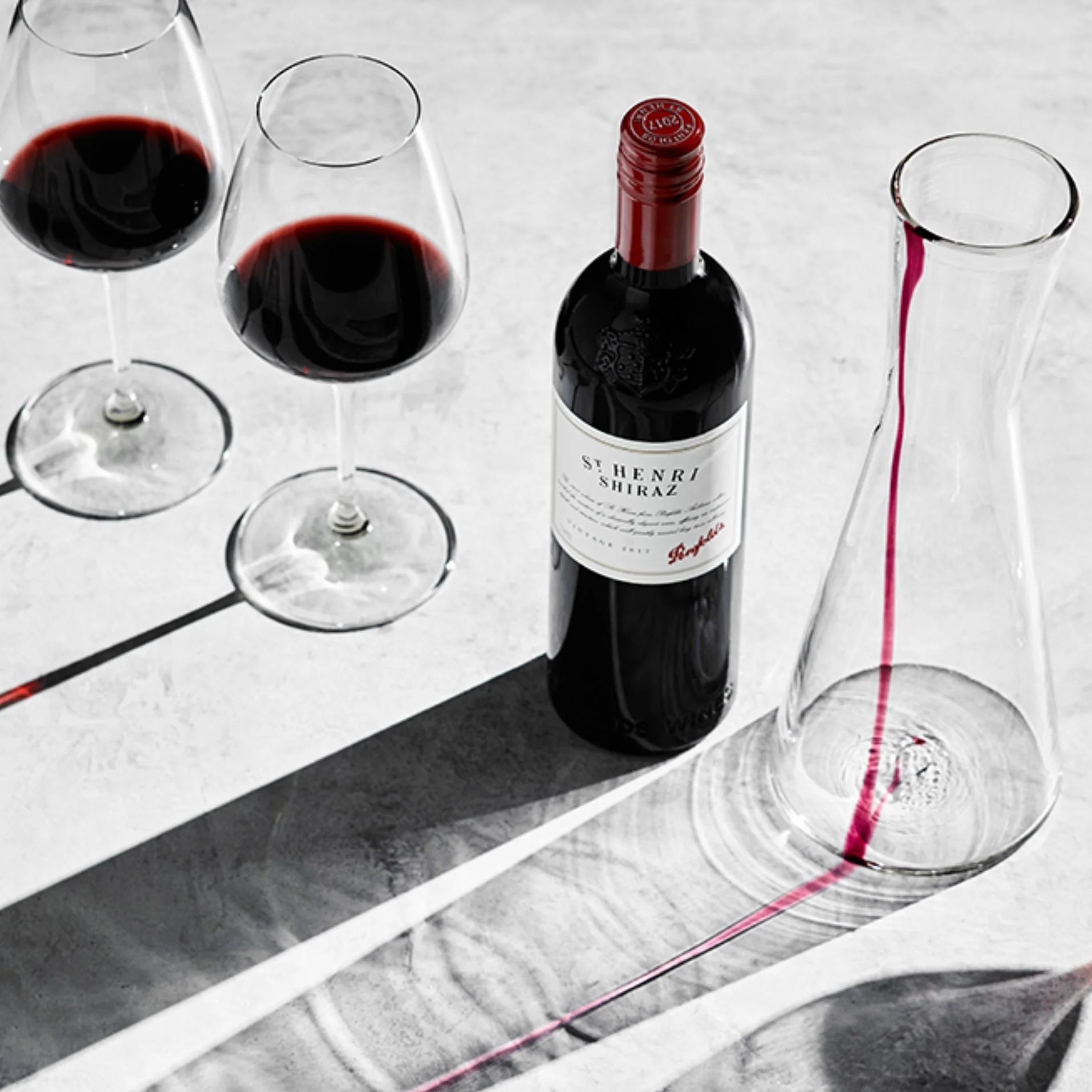 Load image into Gallery viewer, Bottle of Penfolds St. Henri Shiraz red wine with two glasses and a decanter on a marble surface