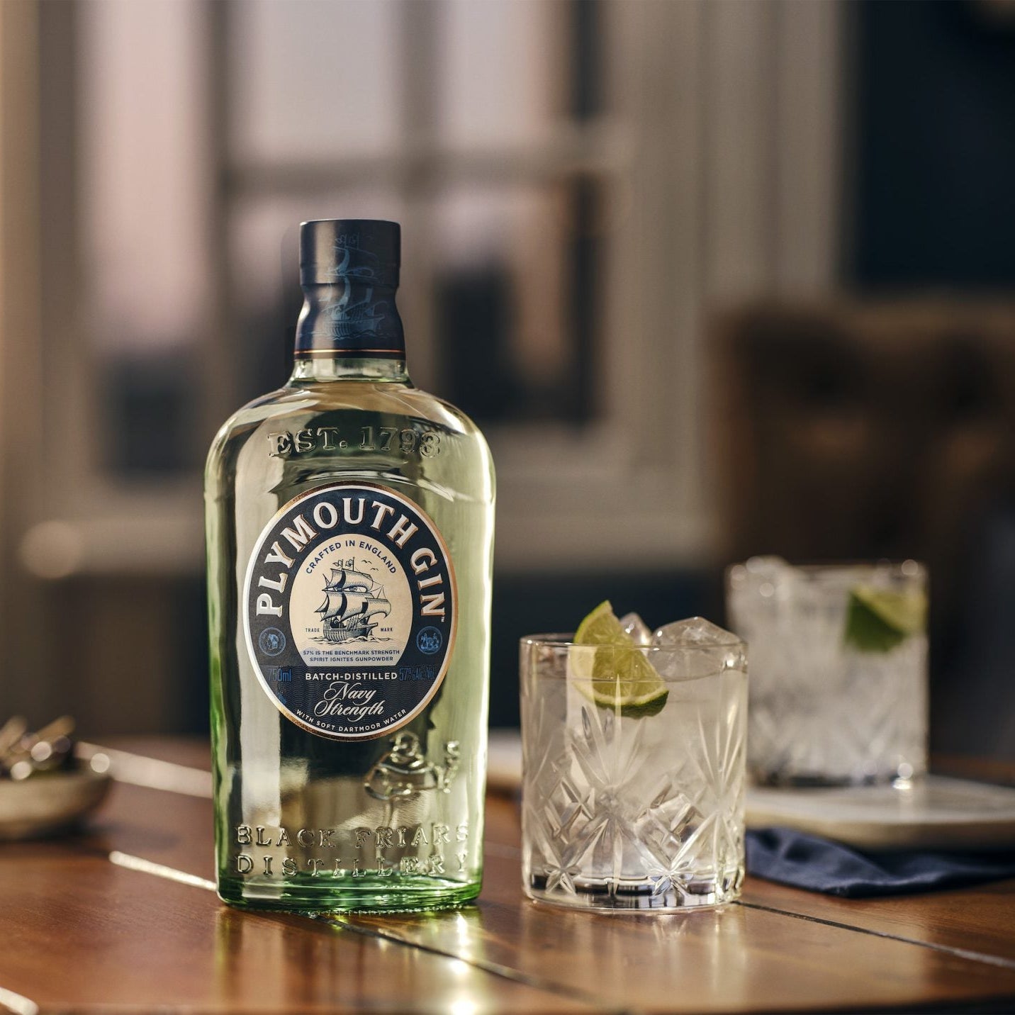Load image into Gallery viewer, Plymouth Navy Gin bottle on a wooden table with a blurred background