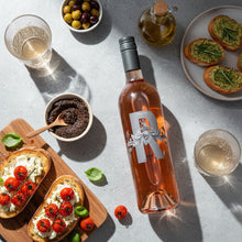 Load image into Gallery viewer, Bottle of Poderi Crisci Rosé wine with appetizers on a light gray surface