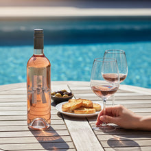 Load image into Gallery viewer, Bottle of Poderi Crisci Rosé wine with two glasses by a poolside