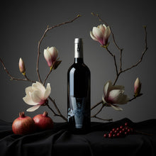 Load image into Gallery viewer, Bottle of Poderi Crisci Viburno red wine next to flowers and red berries and red fruit