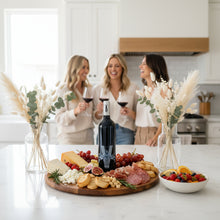 Load image into Gallery viewer, Three women in a modern kitchen talking and drinking a bottle of Bottle of Poderi Crisci Viburno red wine
