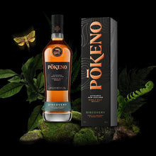 Load image into Gallery viewer, Pokeno Discovery whisky bottle and packaging with a dark background and green leaves.