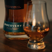 Load image into Gallery viewer, Bottle of Pokeno Discovery whisky with a glass of whiskey on a wooden surface
