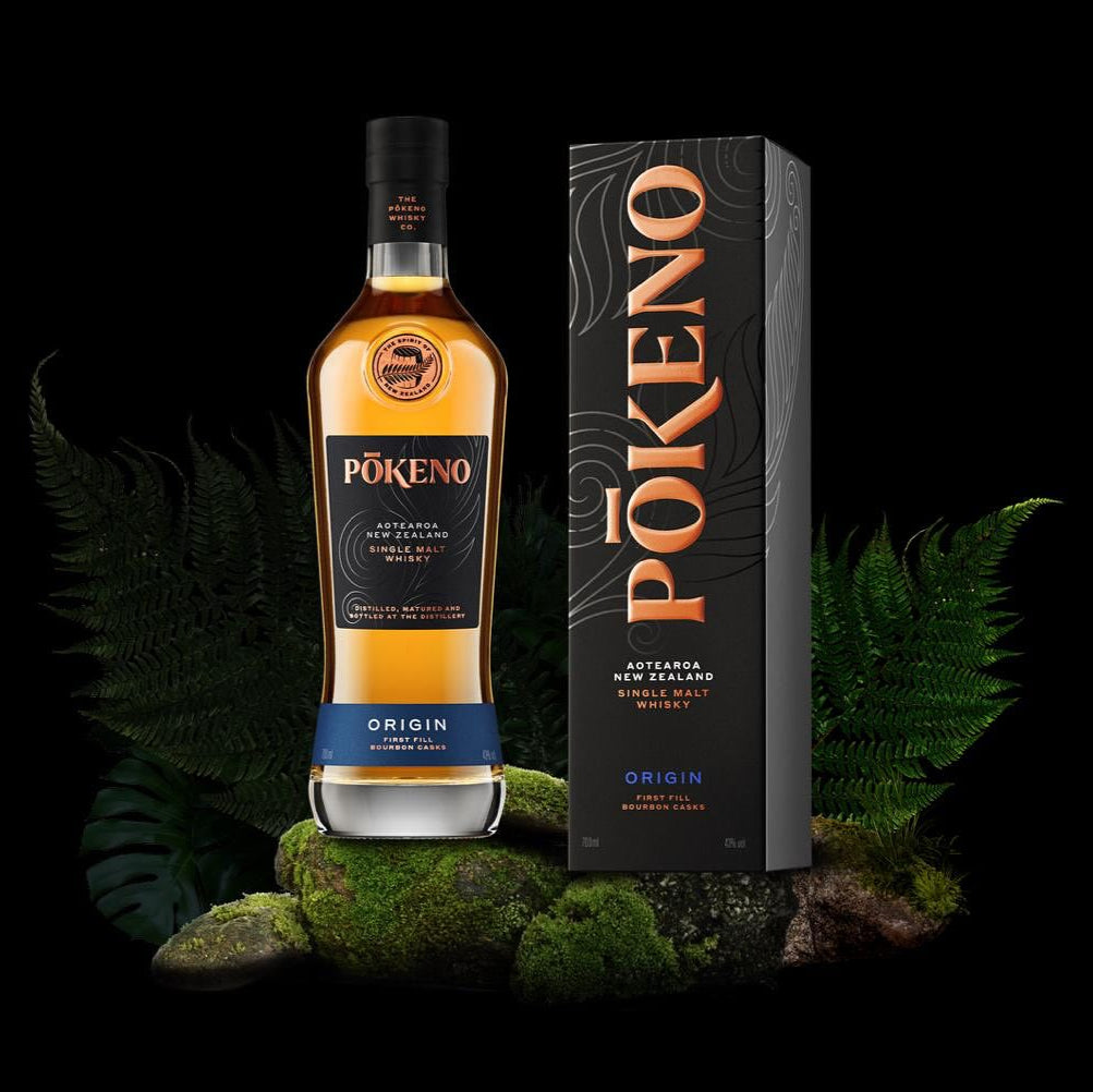 Load image into Gallery viewer, Pokéno whiskey bottle and packaging on a dark background with greenery