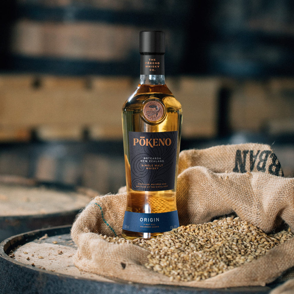 Pokeno Origin whisky bottle on a barrel with barrels in the background