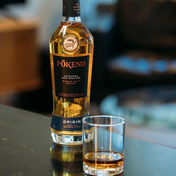 Load image into Gallery viewer, Bottle of Pokeno Origin whisky with a glass on a table