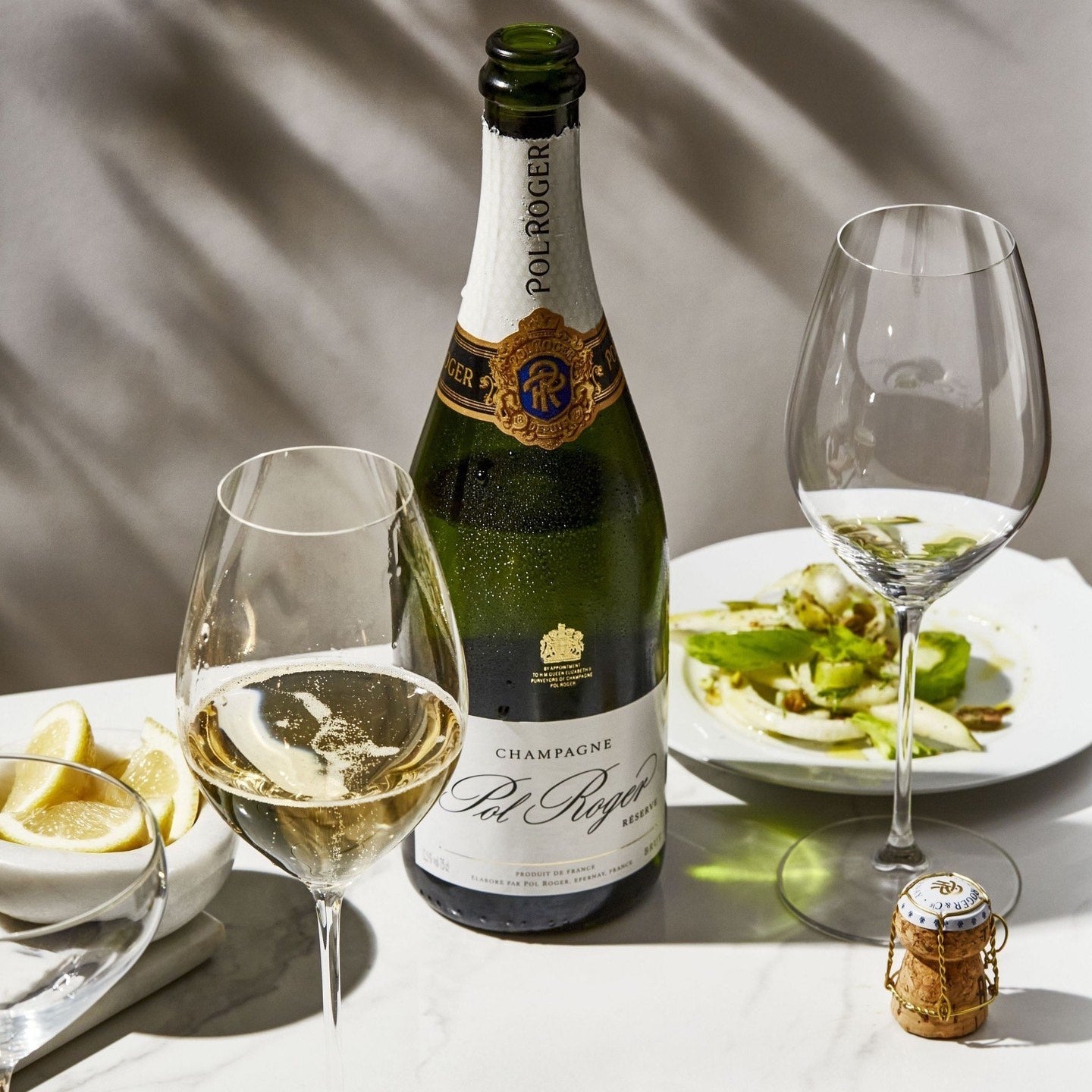Load image into Gallery viewer, A bottle of champagne and food on a table with a grey background