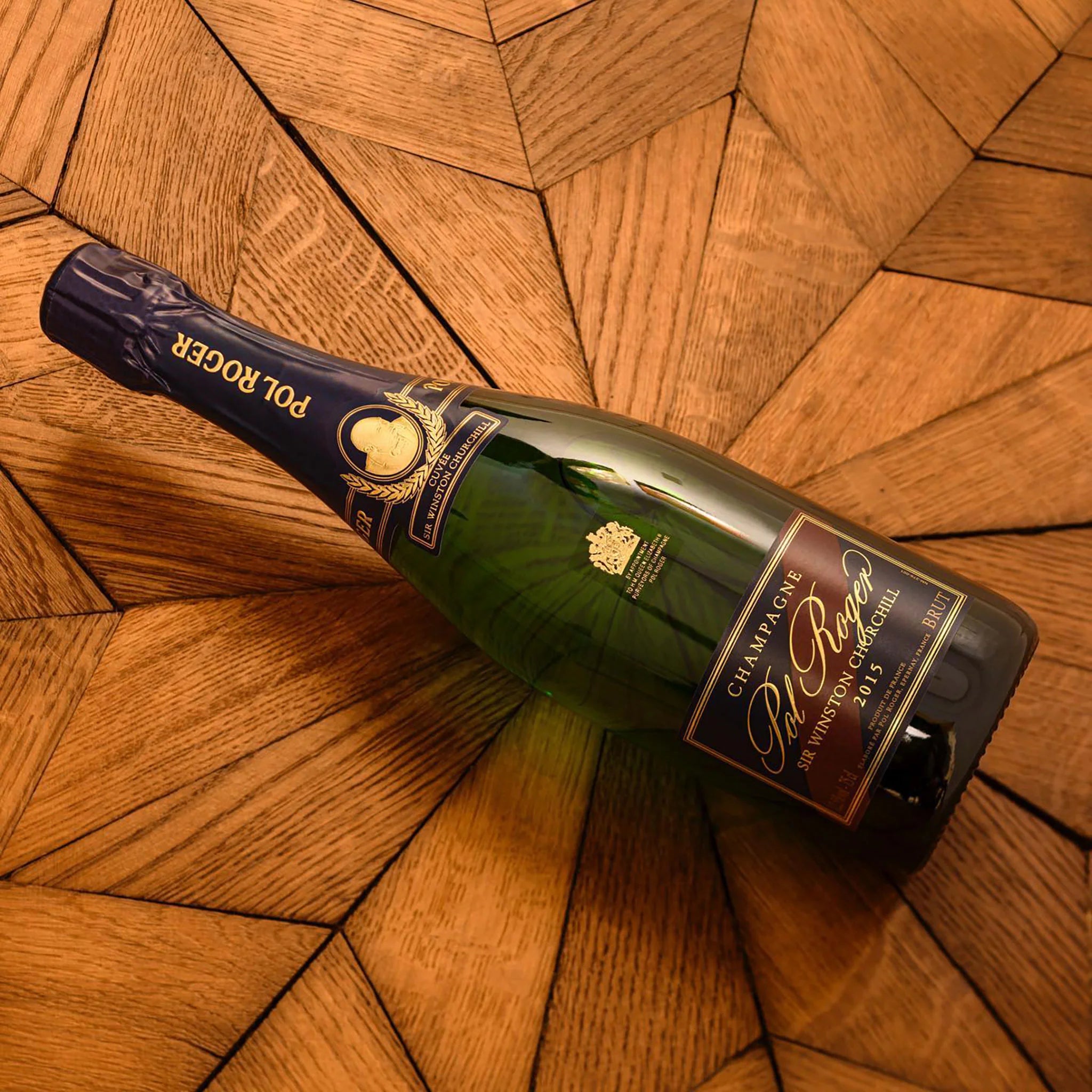 Load image into Gallery viewer, Bottle of POL ROGER Cuvée Sir Winston Churchill Champagne on a wooden surface