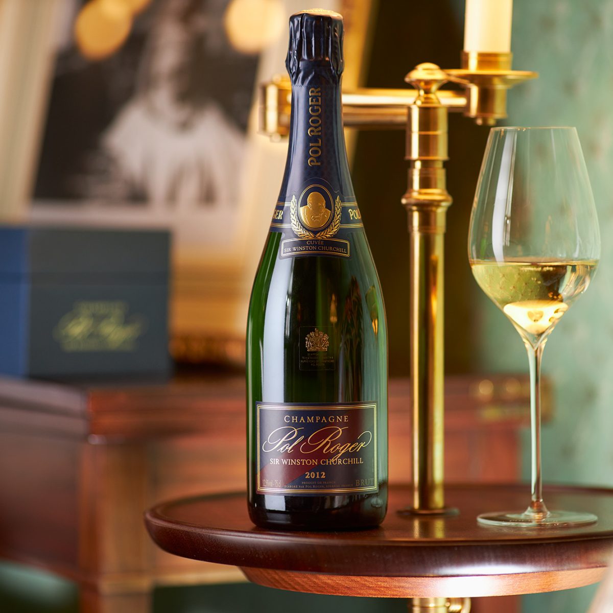 Load image into Gallery viewer, POL ROGER Cuvée Sir Winston Churchill Champagne bottle with a glass on a wooden table