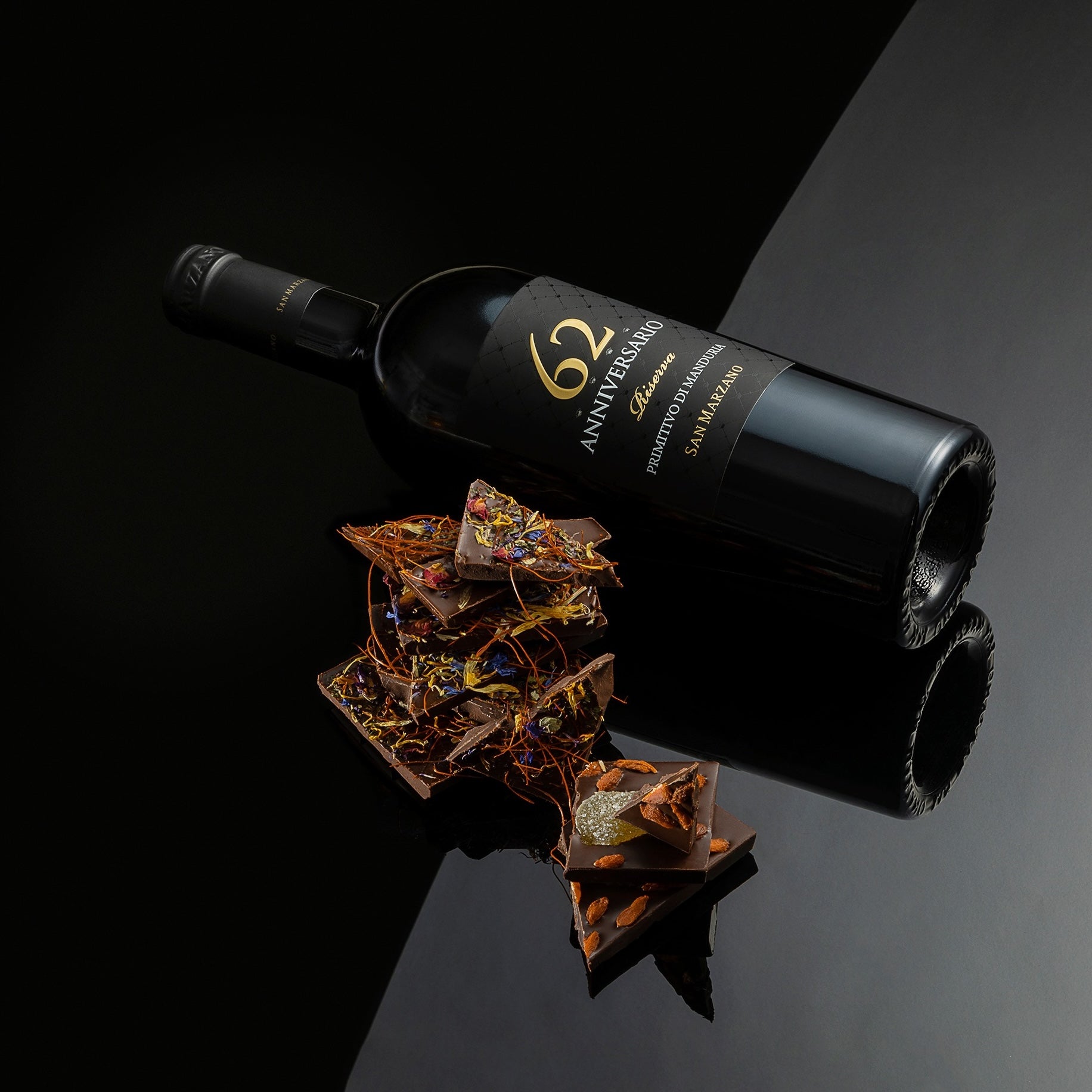 Load image into Gallery viewer, A bottle of Primitivo di Manduria Riserva Anniversario 62 San Marzano next to some artisan chocolate.