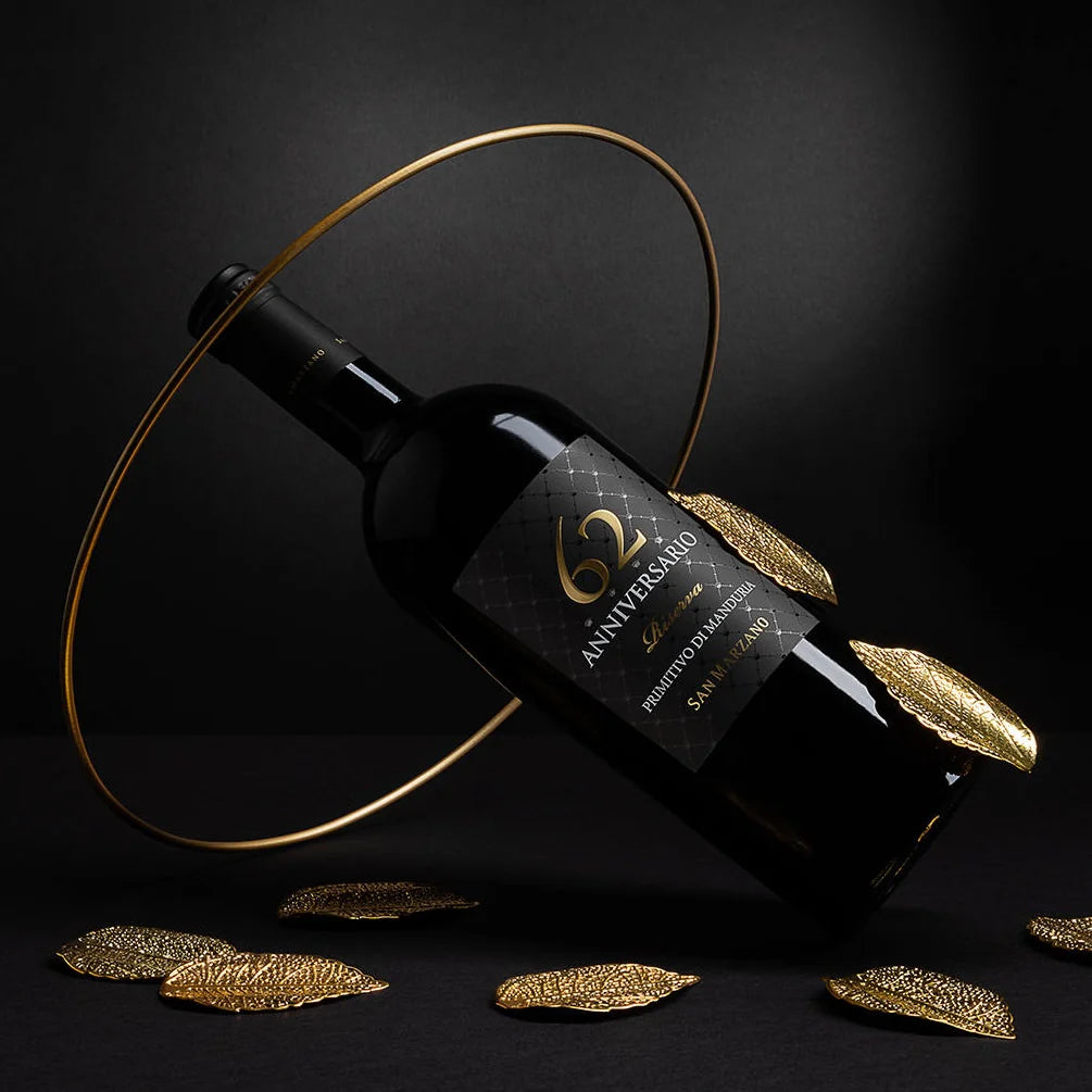Load image into Gallery viewer, Wine bottle with decorative gold leaves on a dark background