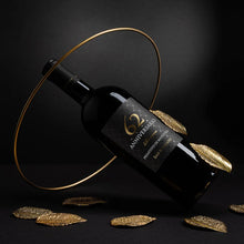Load image into Gallery viewer, Wine bottle with decorative gold leaves on a dark background