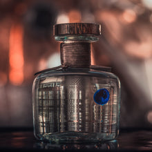 Load image into Gallery viewer, Procera Blue Dot Kenyan Gin on a blurred bar background