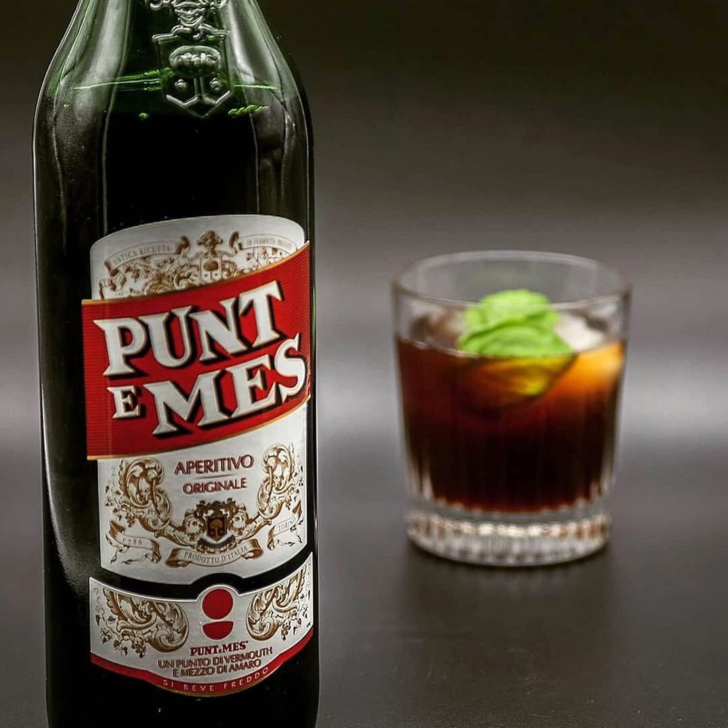 Load image into Gallery viewer, Bottle of Punt e Mes aperitivo with a glass of the drink on a dark background
