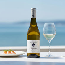 Load image into Gallery viewer, Bottle of Raats Original Chenin Blanc wine with a glass and plate on a table by the sea