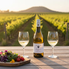Load image into Gallery viewer, Bottle of Raats Original Chenin Blanc wine and two glasses on a wooden table with vineyard background