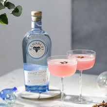 Load image into Gallery viewer, Bottle of Ramsbury vodka with two pink cocktails on a table.