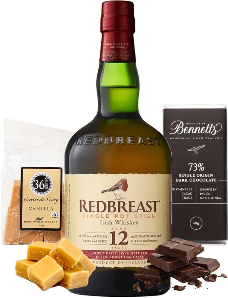 Load image into Gallery viewer, Redbreast Irish Whiskey bottle with chocolate and fudge on a white background