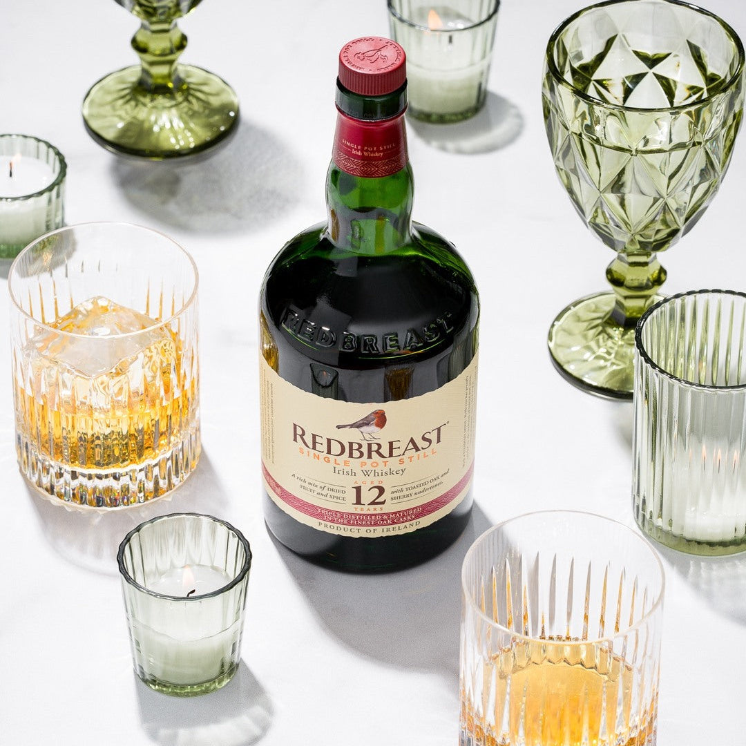 Load image into Gallery viewer, Redbreast 12 year old Irish whiskey bottle with glasses on a white surface