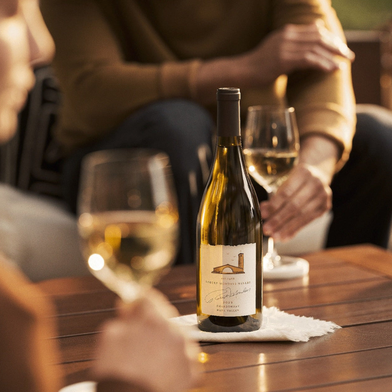 Load image into Gallery viewer, People sitting down enjoying a bottle of white wine