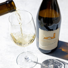 Load image into Gallery viewer, A bottle of Robert Mondavi Napa Chardonnay and someone pouring a glass of wine on a white background