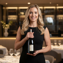 Load image into Gallery viewer, Woman holding a bottle of Rockburn-The-Art-Central-Otago-Pinot-Noir wine in a restaurant setting
