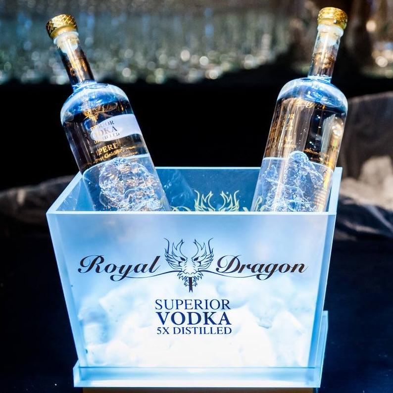 Two bottles of Royal Dragon Superior Vodka in an ice bucket with a blurred background.