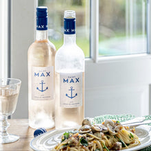 Load image into Gallery viewer, Lifestyle image of a bottle of Saint Max Cotes De Provence Rose next to a delicious pasta meal