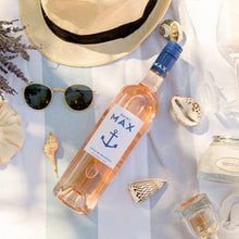 Load image into Gallery viewer, Lifestyle image of a bottle of Saint Max Cotes De Provence Rose in summer setting on table