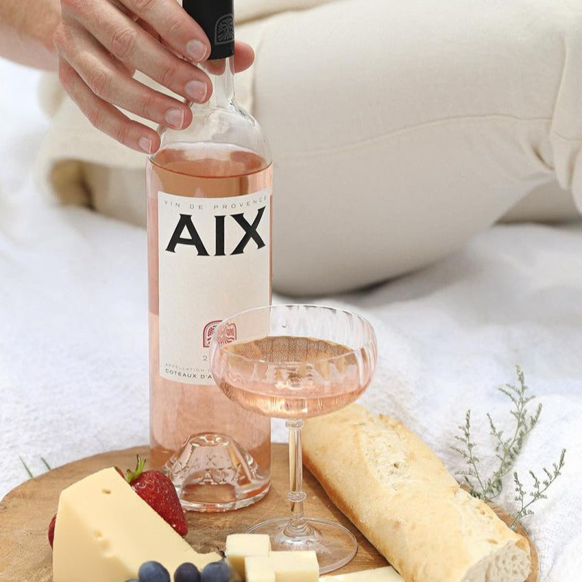 Load image into Gallery viewer, A bottle of Maison Saint AIX rose on a cheeseboard and a glass of wine