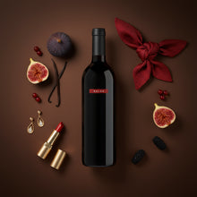Load image into Gallery viewer, Bottle of Saldo Zinfandel red wine with decorative elements on a brown background